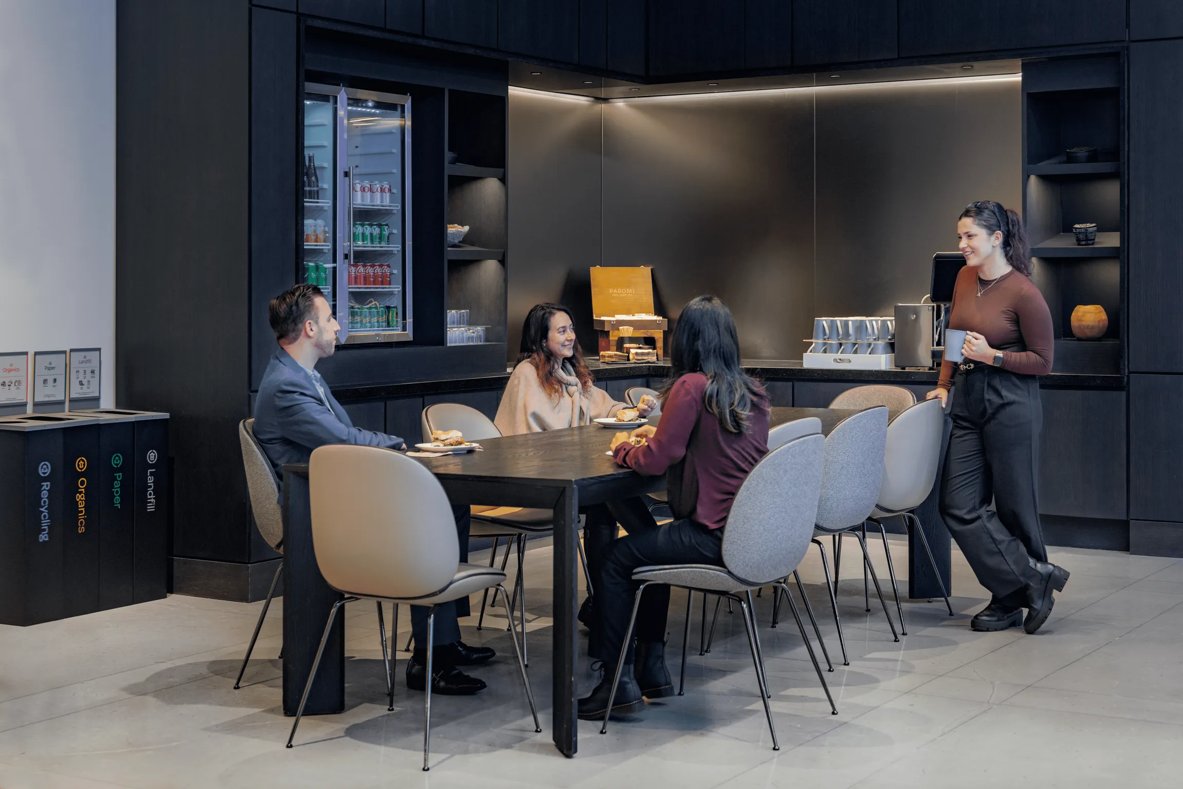 People chatting and eating at a table in a cozy restaurant setting