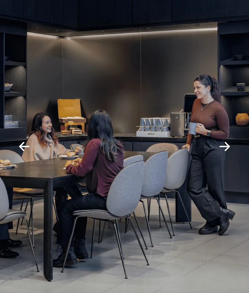 People chatting and eating at a table in a cozy restaurant setting